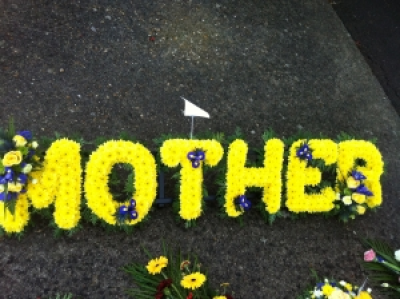 personal funeral tribute - beautiful based lettering in yellow or white with complimenting floral sprays personal funeral tribute - beautiful based lettering in yellow or white with complimenting floral sprays