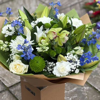 Tranquil Sky - Soothing whites, soft greens and delicate blues combine in this calming bouquet with roses, orchids, delphiniums and lisianthus. A serene statement. Tranquil Sky - Soothing whites, soft greens and delicate blues combine in this calming bouquet with roses, orchids, delphiniums and lisianthus. A serene statement.