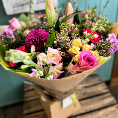 Bloom Boutique - A luxuriously full bouquet with a rich mix of pink roses, waxflower, dahlias, and spray roses in a bright, cheerful palette. Makes a bold gifting statement. Bloom Boutique - A luxuriously full bouquet with a rich mix of pink roses, waxflower, dahlias, and spray roses in a bright, cheerful palette. Makes a bold gifting statement.